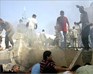 Palestinians  search for survivors after an air strike in Gaza City