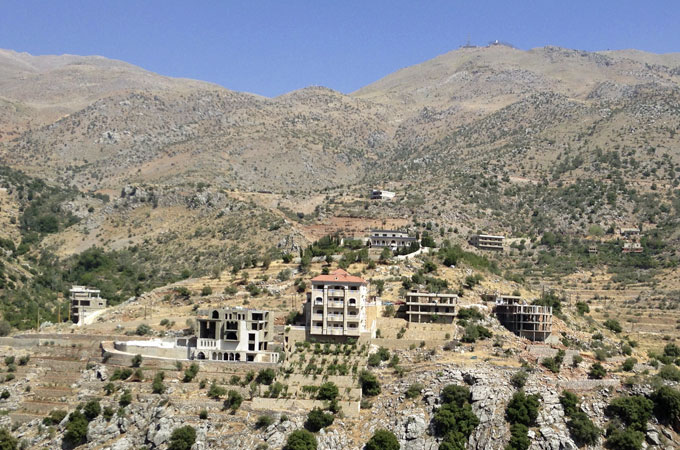 The small town of Shebaa in southern Lebanon is overlooked by an Israeli military installation on the next mountaintop [Nour Samaha/Al Jazeera]