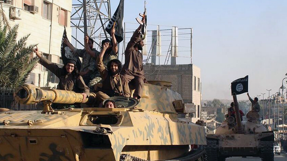 ISIL fighters during a parade in Raqqa, Syria [AP]