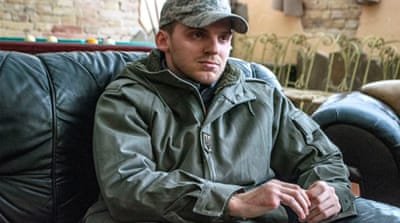 Commander of St Mary’s, Borgese 'Alex' Serediuk, lost his pinky finger in battle [Abed al-Qaisi/Al Jazeera] 