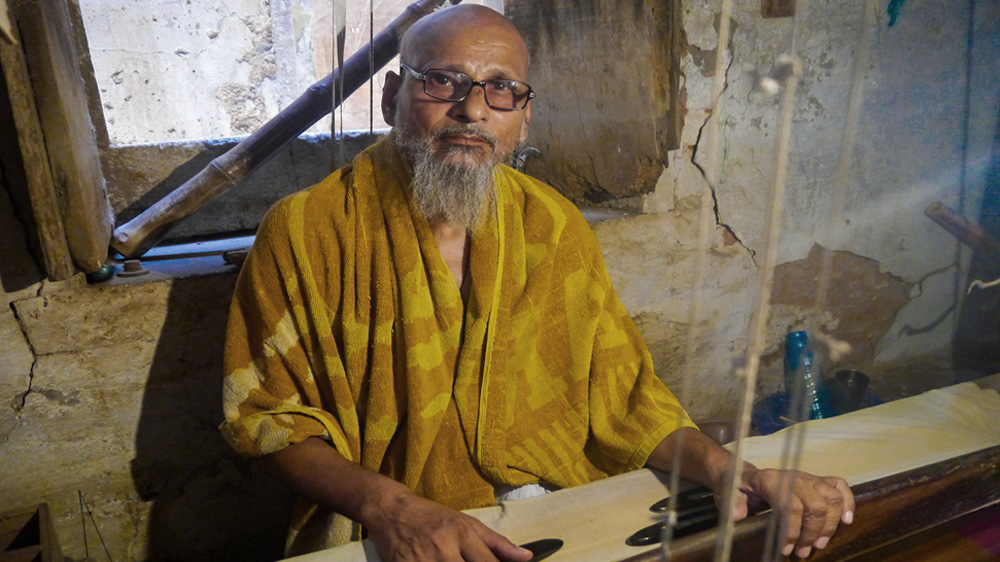 Mohammad Iliyas, a Muslim weaver said business hasn't been good under the new government [Baba Umar/Al Jazeera]