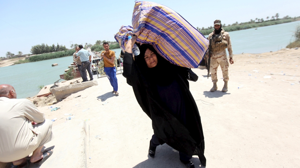 Displaced Sunni people fleeing the violence in the city of Ramadi arrive at the outskirts of Baghdad