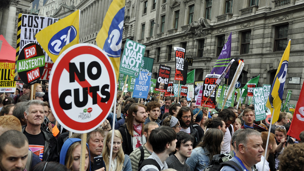 The government will announce measures next month to reduce the UK's welfare expenditure by 12 billion pounds ($19bn) a year [Simon Hooper/Al Jazeera]
