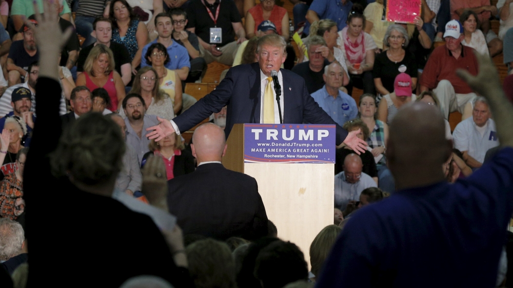 Audience members raise their hands to ask U.S. Republican presidential candidate Donald Trump a question at a campaign town hall meeting in Rochester