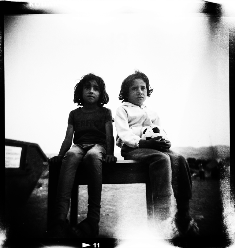 Syrian children sit in front of the abandoned hotel Captain Elias - Kos, Greece, August 2015 [Giorgos Moutafis]