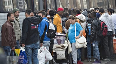 Migrants, mainly from Syria, prepare to board a train in southern Denmark headed for Sweden [Al Jazeera]