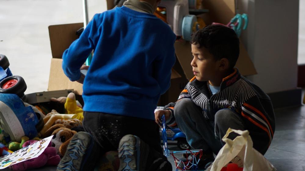 Children play in Elliniko Refugee Temporary Centre [Sorin Furcoi/Al Jazeera]