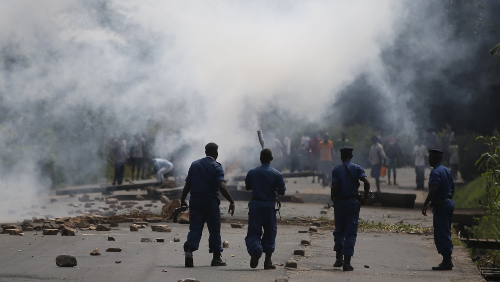 File photo of policemen walking after they fired tear gas canisters at protesters during a protest against Burundi President Pierre Nkurunziza and his bid for a third term in Bujumbura