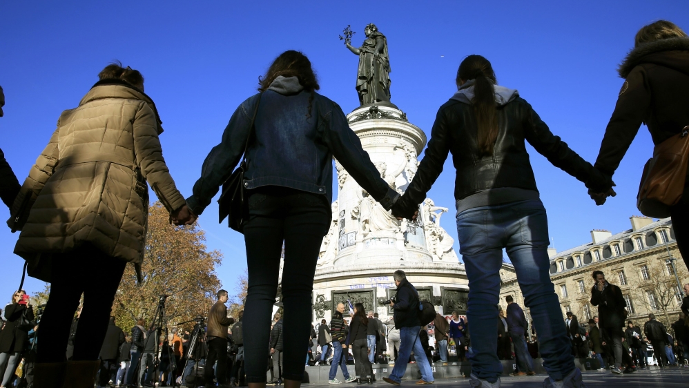 People hold hands to form a human solidarity chain near the site of the attack at the Bataclan concert hall in Paris