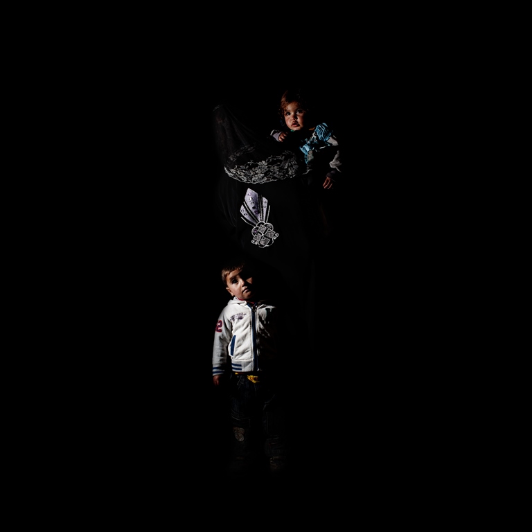 Thirty-five-year-old Mariam came to Lebanon from Aleppo three years ago. Her husband doesn’t work and she has six children. Her oldest is only 12. In the portrait with her is three-year-old Ali and one-year-old Aisha. Both were born in Lebanon. Ali has a birth certificate but Aisha does not. Mariam wants to be able to register them in order to take them back to Syria when the war ends  [Felipe Jacome/Al Jazeera]   