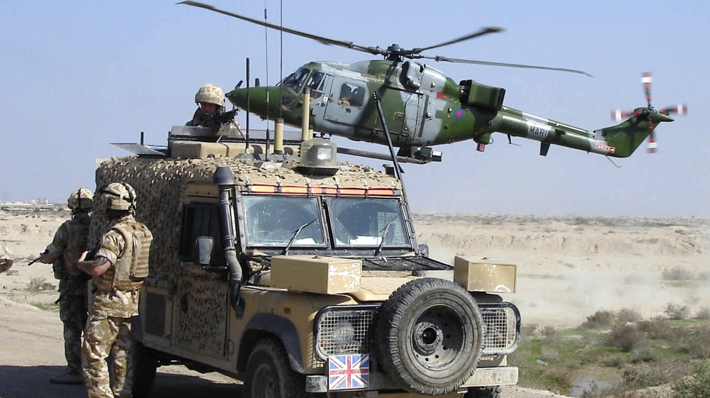 File photo of a Royal Marines helicopter preparing to land as British forces in a Snatch Land Rover set up a checkpoint south of Basra
