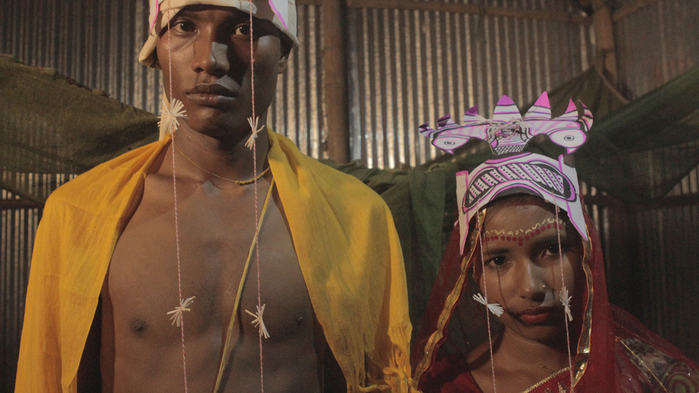 Thirteen-year-old Beezly and her husband Shyamal on their wedding day. According to Bangladeshi law child marriage is illegal but it continues to happen in secret [Sumon Sarker/Al Jazeera]