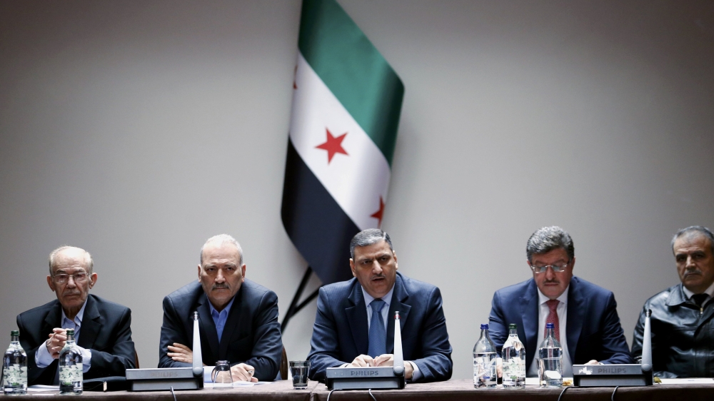 Dr Riad Hijab, centre, was Syria's prime minister until he defected in August 2012 [File: Denis Balibouse/Reuters]