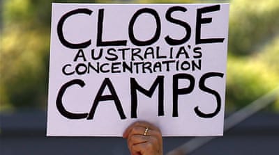 A protester holds a placard during a rally in support of refugees in central Sydney, Australia [David Gray/Reuters]
