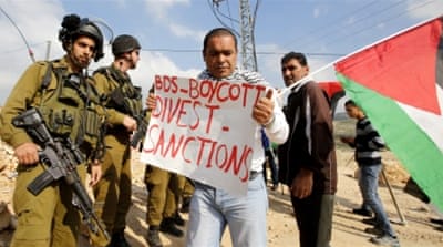 Israeli soldiers block Palestinian BDS protesters from advancing near a southern West Bank village [EPA]