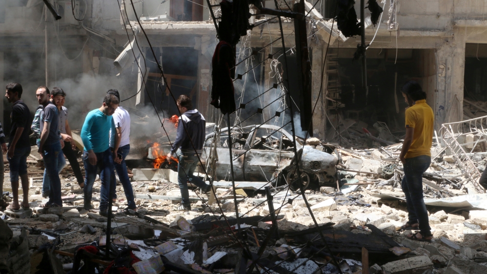 People inspect the damage at a site hit by airstrikes, in the rebel-held area of Aleppo''s Bustan al-Qasr