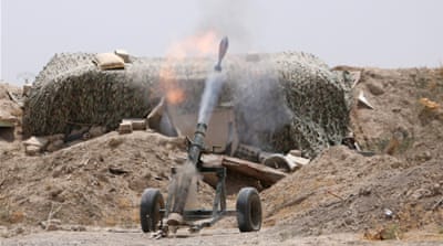 Fighters of the Syria Democratic Forces fire a mortar shell towards positions held by Islamic State fighters in northern province of Raqqa