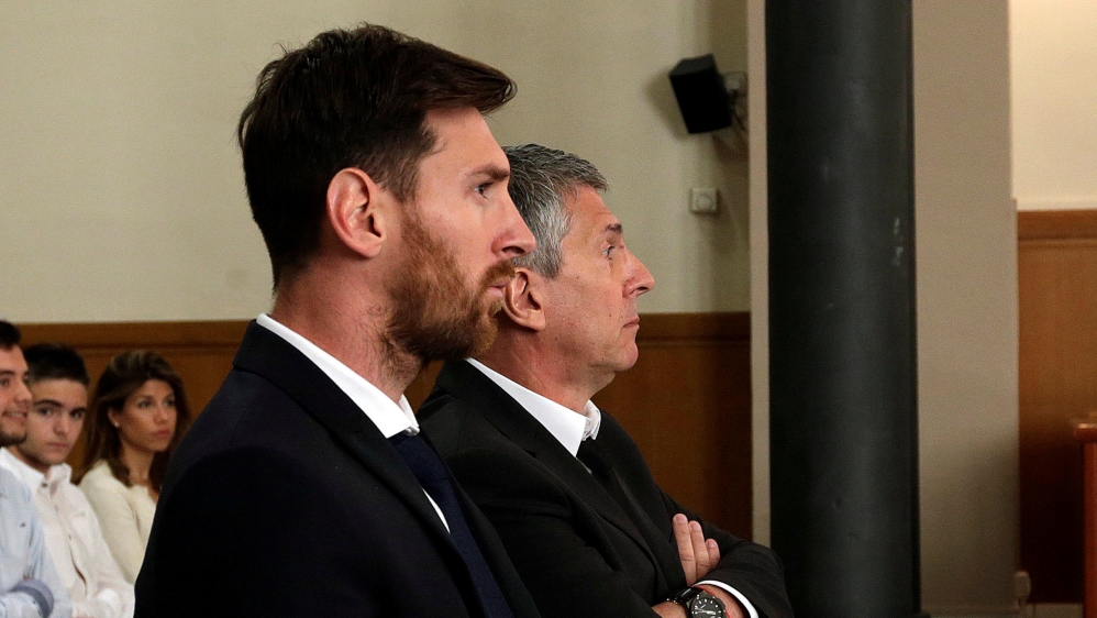 Barcelona''s Argentine soccer player Lionel Messi sits in court with his father Jorge Horacio Messi during their trial for tax fraud in Barcelona
