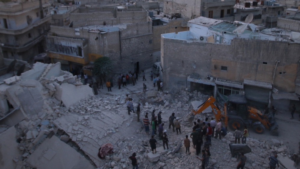 Men inspect damage after an airstrike on Aleppo''s rebel held al-Hallak neighbourhood