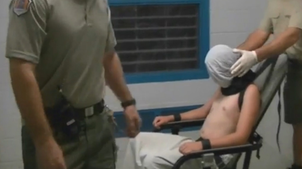 CCTV footage from the Don Dale Youth Detention Centre shows a boy hooded and strapped to a mechanical chair  [EPA]