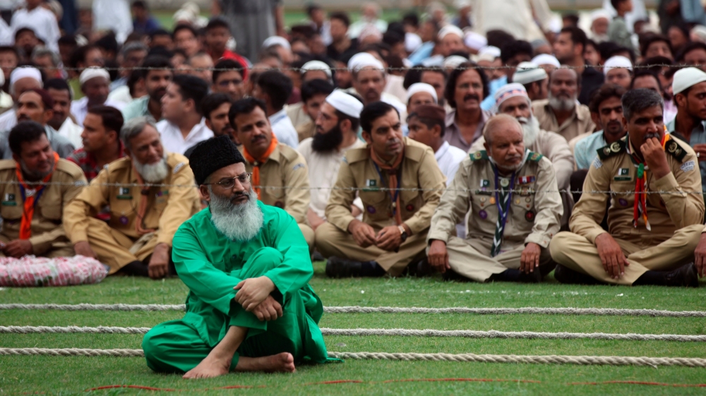 People wait for start of the funeral of Abdul Sattar Edhi at the National Stadium in Karachi
