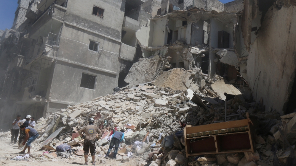 Residents inspect a damaged site after an airstrike on Aleppo''s rebel held Al-Mashad neighbourhood