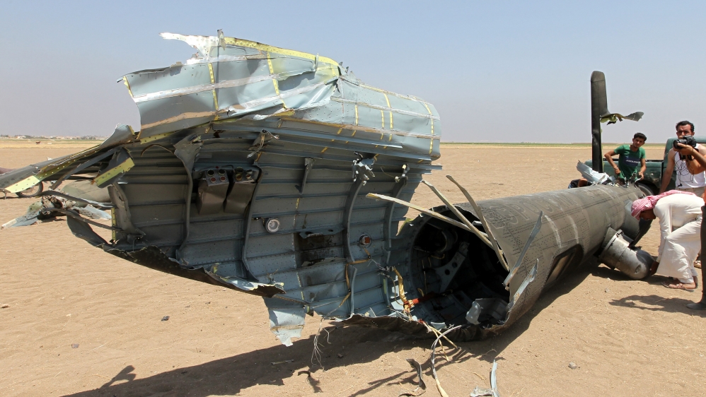 Men inspect the wreckage of a Russian helicopter that had been shot down in the north of Syria''s rebel-held Idlib province