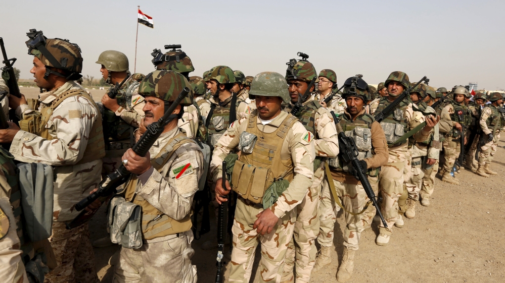 Iraqi security forces wait for vehicles travelling to Mosul to fight against militants of Islamic State at an Iraqi army base in Camp Taji in Baghdad