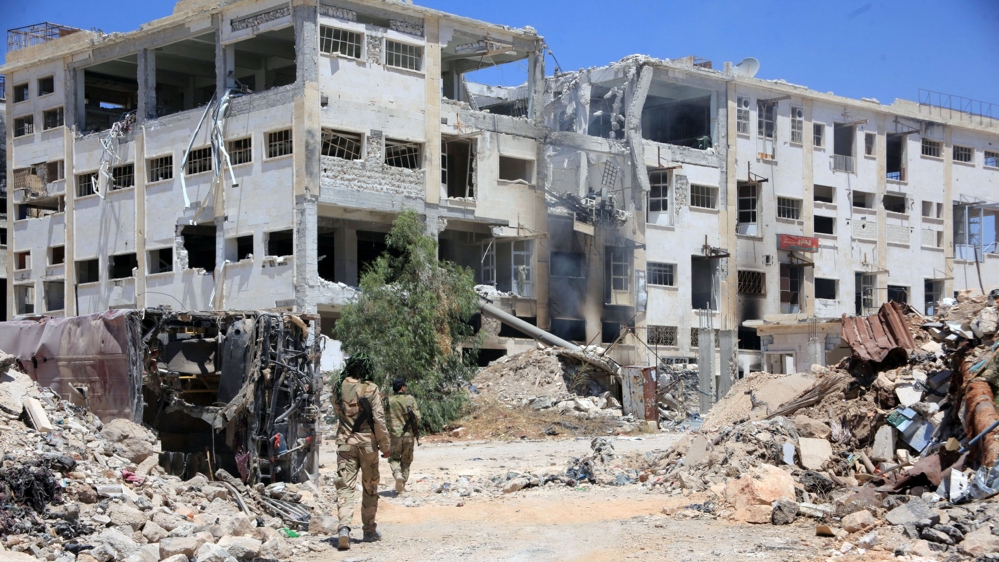 Forces loyal to Syria''s President Bashar al-Assad walk past rubble after they advanced on the southern side of the Castello road in Aleppo