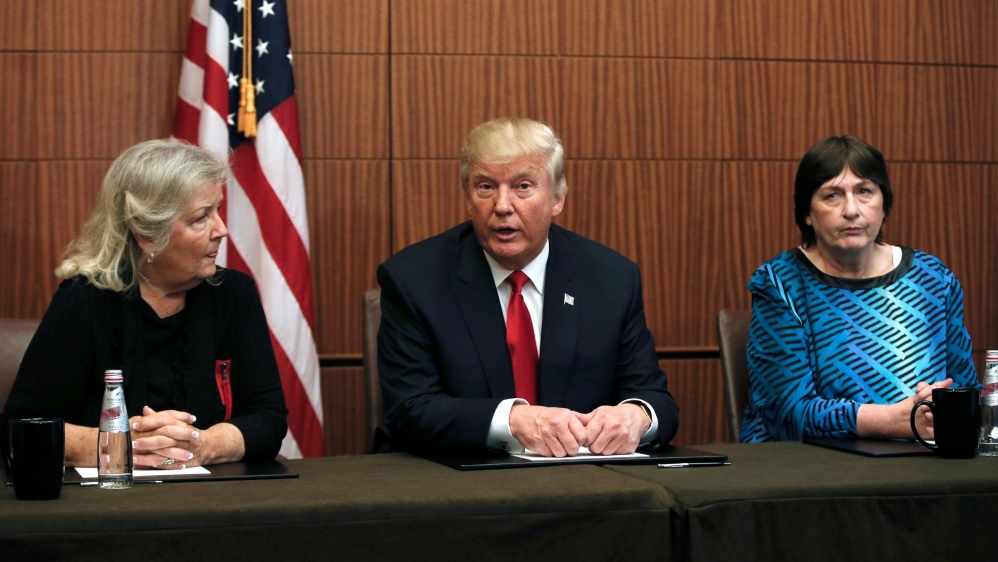 Republican presidential nominee Donald Trump sits with Kathy Shelton and Juanita Broaddrick in a hotel conference room in St. Louis, Missouri