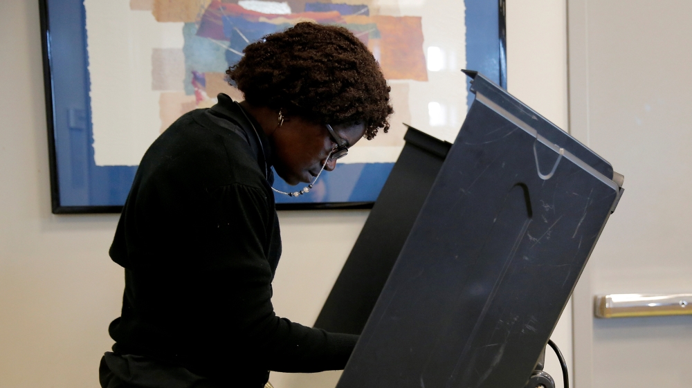 A voter casts her ballot during early voting at the Beatties Ford Library in Charlotte, North Carolina