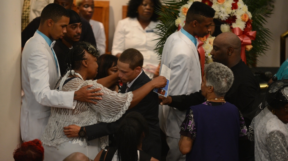 Gwen Carr hugs Ramsey Ortiz during the funeral service of Eric Garner at Bethel Baptist Church in Brooklyn New York