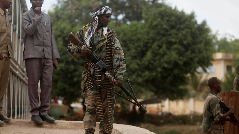 A Somali soldier patrols a street near a bridge following a suicide car bomb and gun attack on Tuesday that killed 11 people in Afgoye, Somalia