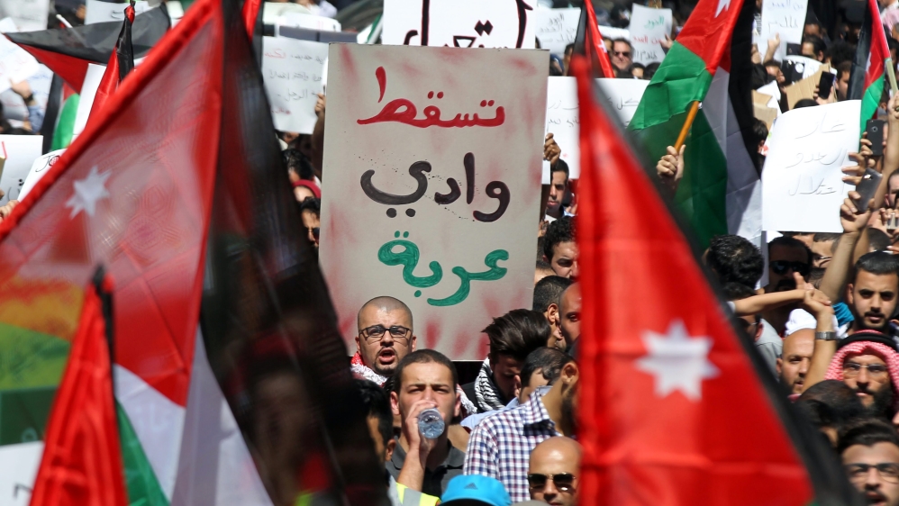 Protesters hold up a sign reading “Down with Wadi Araba”, the peace treaty between Israel and Jordan [EPA]