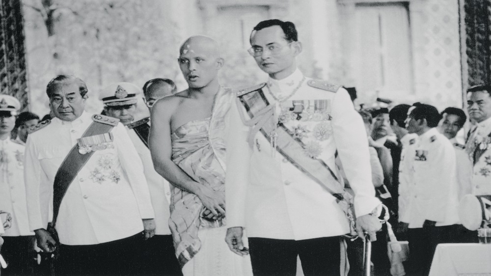King Bhumibol leads his only son, Crown Prince Vajiralongkorn, for his ordination into the Buddhist monkhood [Getty Images]