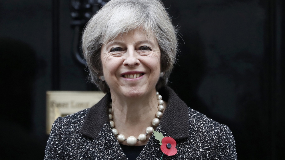 Britain''s Prime Minister Theresa May poses with a poppy after buying it to mark this year''s Poppy Appeal, at Number 10 Downing Street in central London