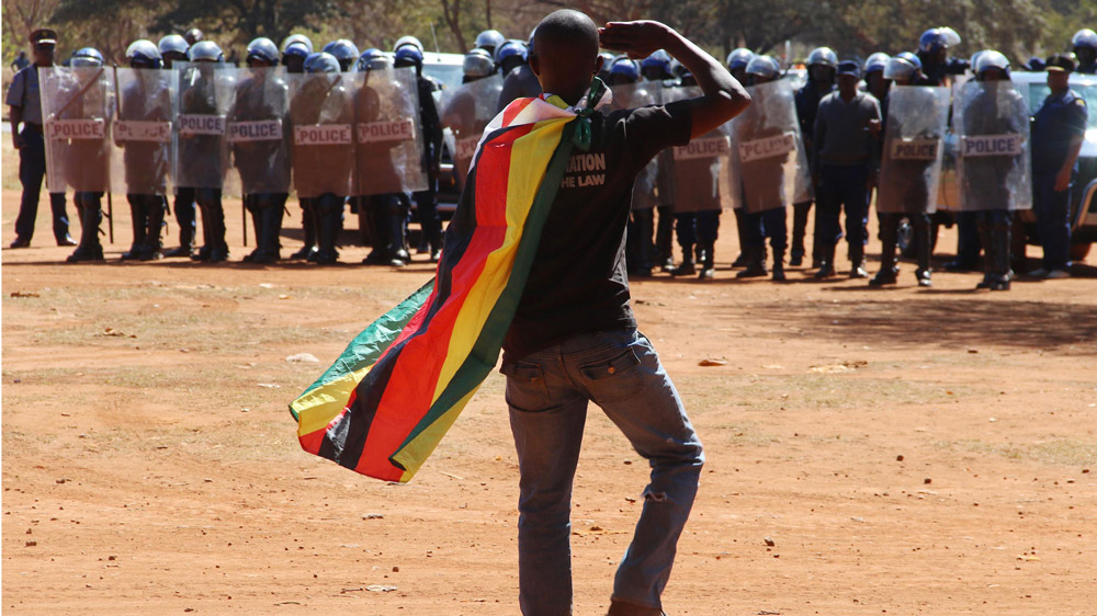A man wearing a Zimbabwean flag