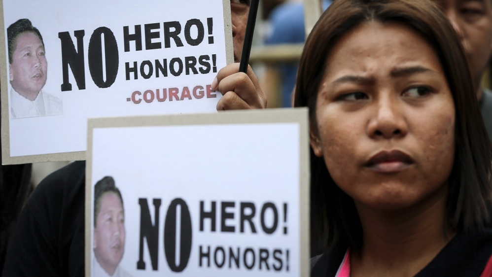 Filipinos protest the burial of former dictator Ferdinand Marcos at the Heroes'' Cemetery in Manila