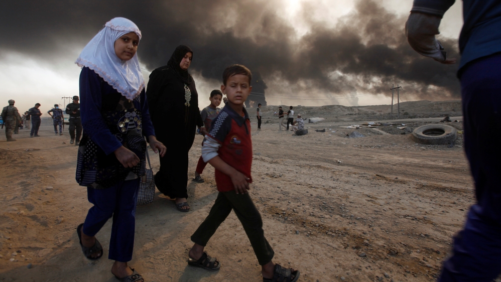 Civilians return to their village after it was liberated from Islamic State militants, south of Mosul in Qayyara