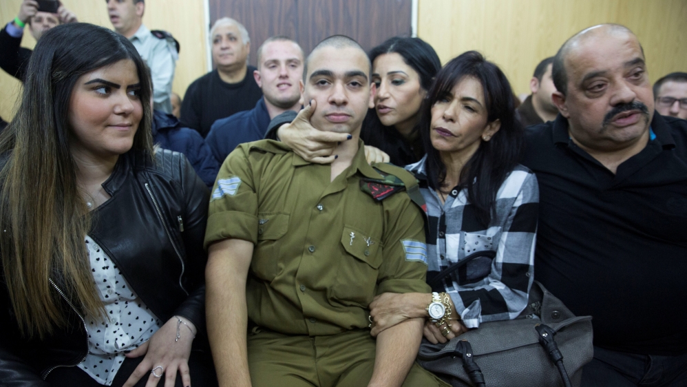 Israeli soldier Elor Azaria, who is charged with manslaughter by the Israeli military, sits to hear his verdict in a military court in Tel Aviv, Israel