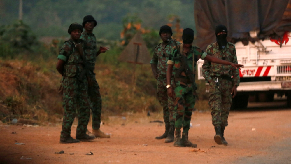 Mutinous soldiers who have taken control of Bouake stand at a checkpoint in Bouake