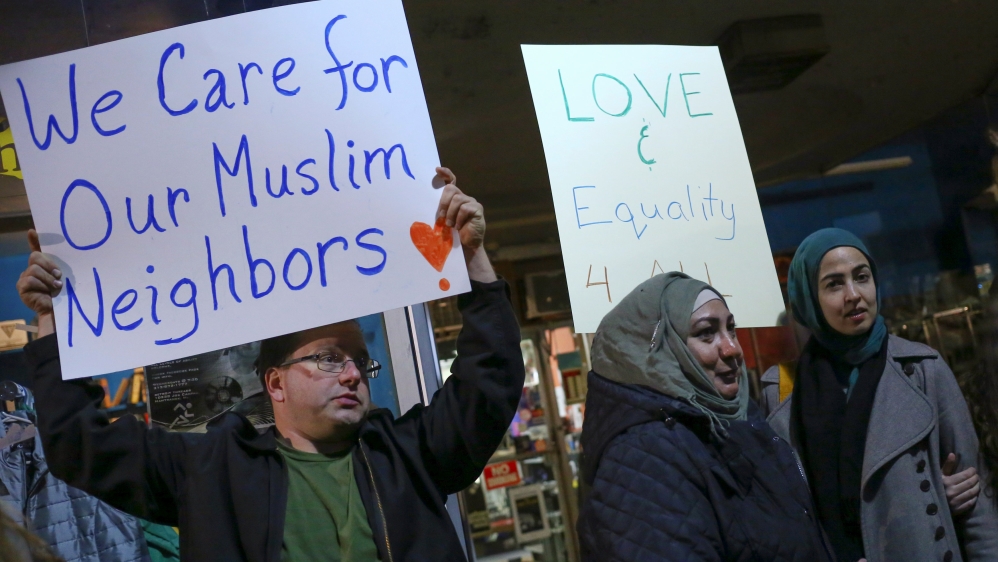 Protesters hold signs during demonstration against President-elect