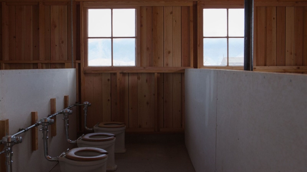 The toilets and showers had no dividers [Jessica Chou/Al Jazeera] 