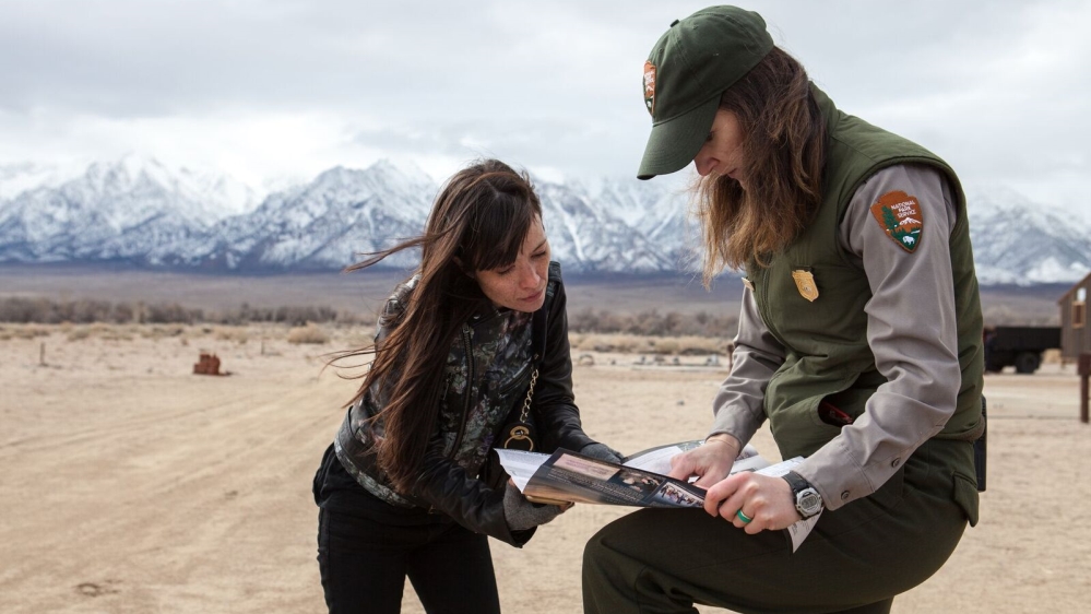 Entering the Manzanar visitors' centre, park rangers greet Nakamaru [Jessica Chou/Al Jazeera]