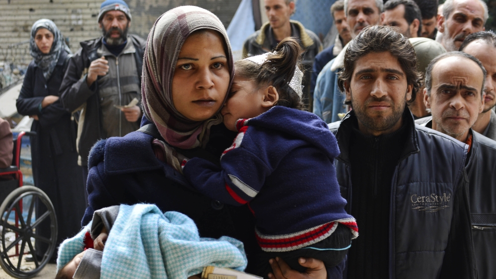 Residents queue up to receive humanitarian aid in Yarmouk [File: Reuters]