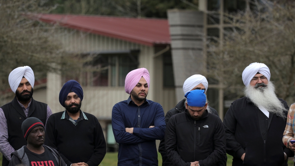 Sikh men listen during a vigil in honor of Srinivas Kuchibhotla, an immigrant from India who was recently shot and killed in Kansas, at Crossroads Park in Bellevue, Washington