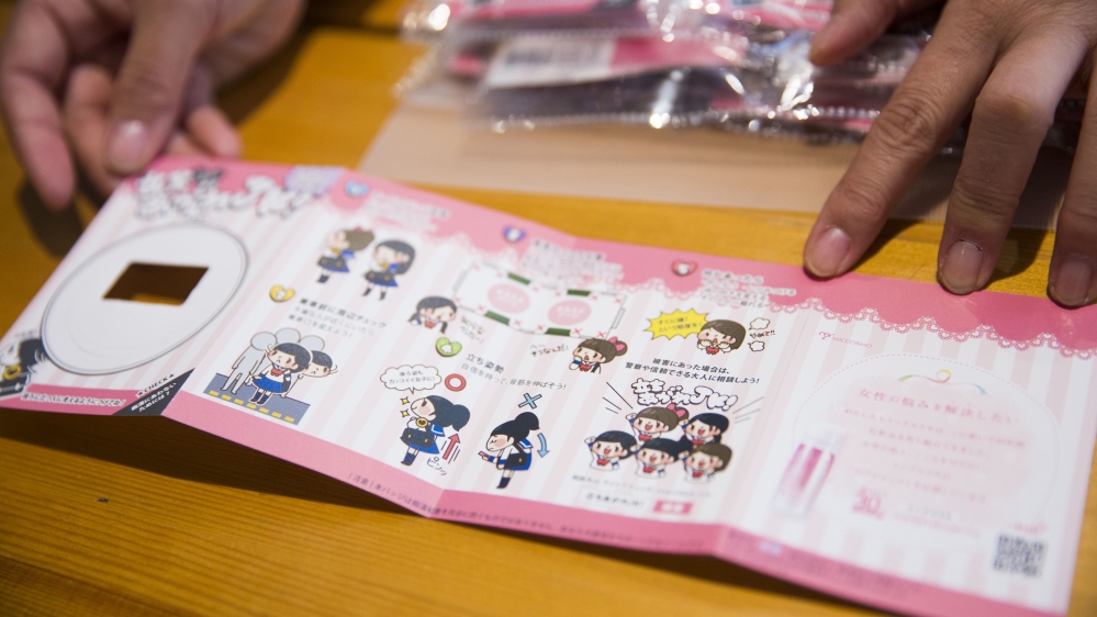 Each of the badges sold by Matsunaga's organisation comes with instructions for girls on how to prevent or respond to groping on trains [Shiori Ito/Al Jazeera]