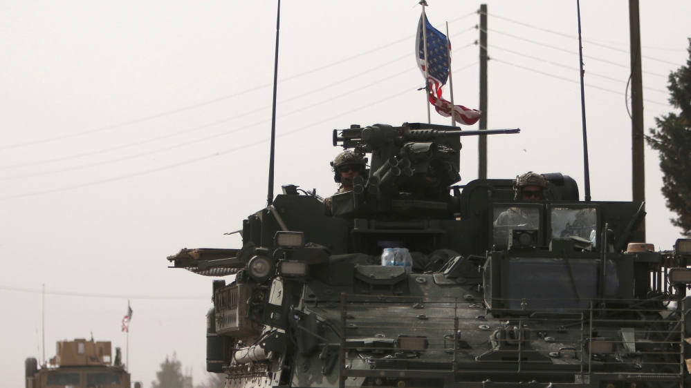 FILE PHOTO: U.S. army vehicles drive north of Manbij city