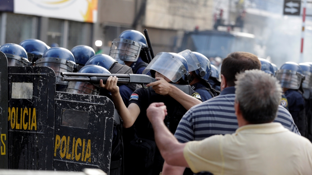 
The fire service said about 30 demonstrators and police were hurt [Jorge Adorno/Reuters]
