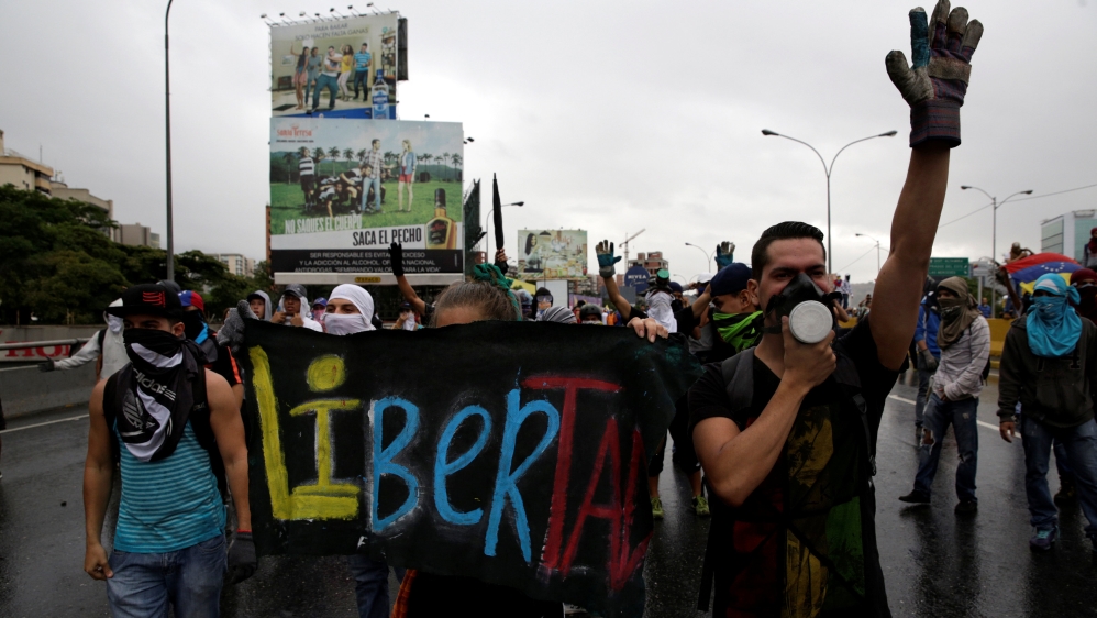 Demonstrators rally against Venezuela''s President Nicolas Maduro, carry a sign that reads "Liberty" in Caracas